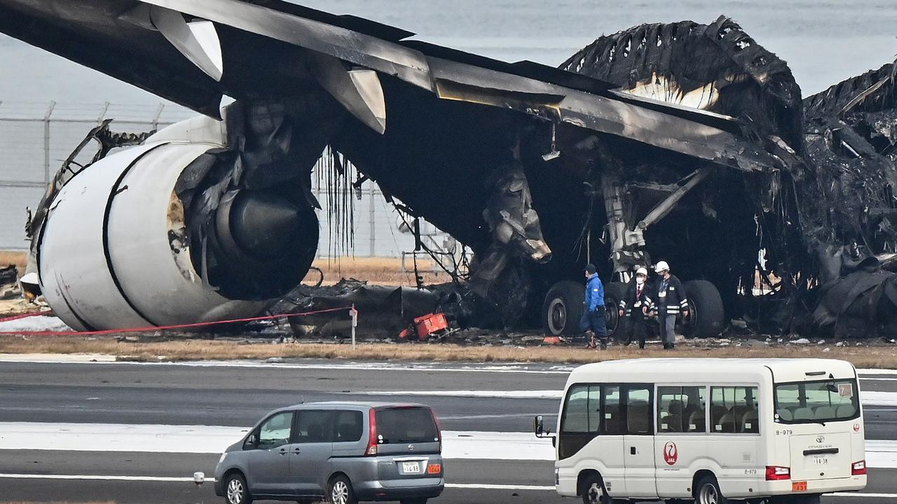 Officials look at the burnt wreckage of the Japan Airlines plane on January 3. Picture: Richard A. Brooks / AFP