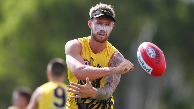 GOLD COAST, AUSTRALIA - JANUARY 30: Nathan Broad handballs during a Richmond Tigers AFL training session at Southport Sharks on January 30, 2020 in Gold Coast, Australia. (Photo by Chris Hyde/Getty Images)