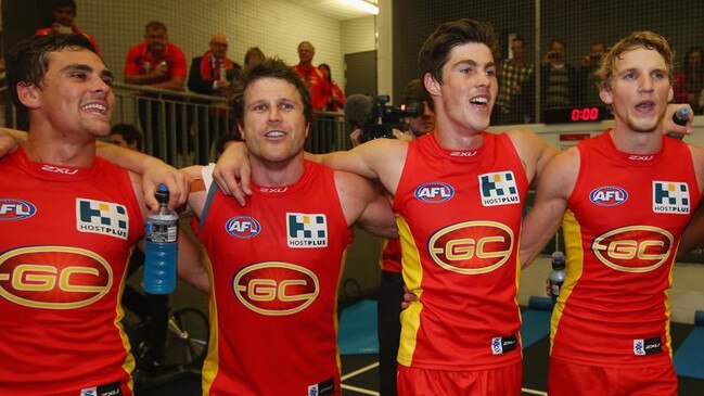 Campbell Brown sings with Gold Coast teammates in his final season. Photo by Chris Hyde/Getty Images.