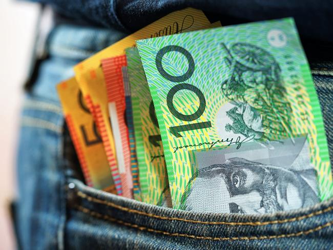 Australian cash money in mans jeans pocket, close up.