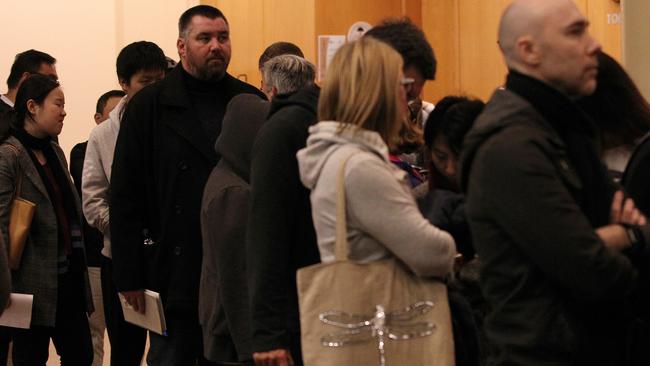 Apartment owners wait in line to vote on the special levy. Picture: AAP