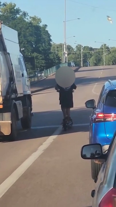 Kids on e-scooter dodge traffic, come close to truck in reckless road stunt