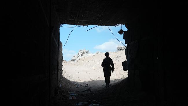 An Israeli soldier stands at the entrance of a tunnel in Rafah in the Gaza Strip on Friday. Picture: AFP