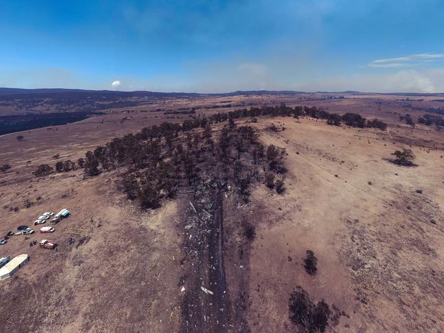 The kilometre-long crash site of the C-130 Hercules has been difficult for investigators because it is in an active bushfire area Source: NSW Police/ATSB