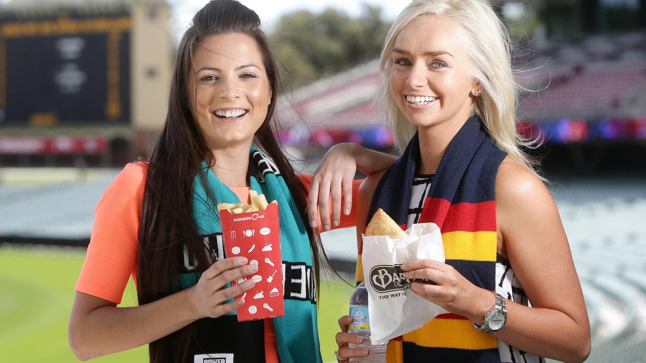 21/03/14 Rebecca Sarti and Elise Partington sample some food at the Adelaide Oval fro a stort on food and beverage prices ahead of next weekend's Showdown. pic Calum Robertson