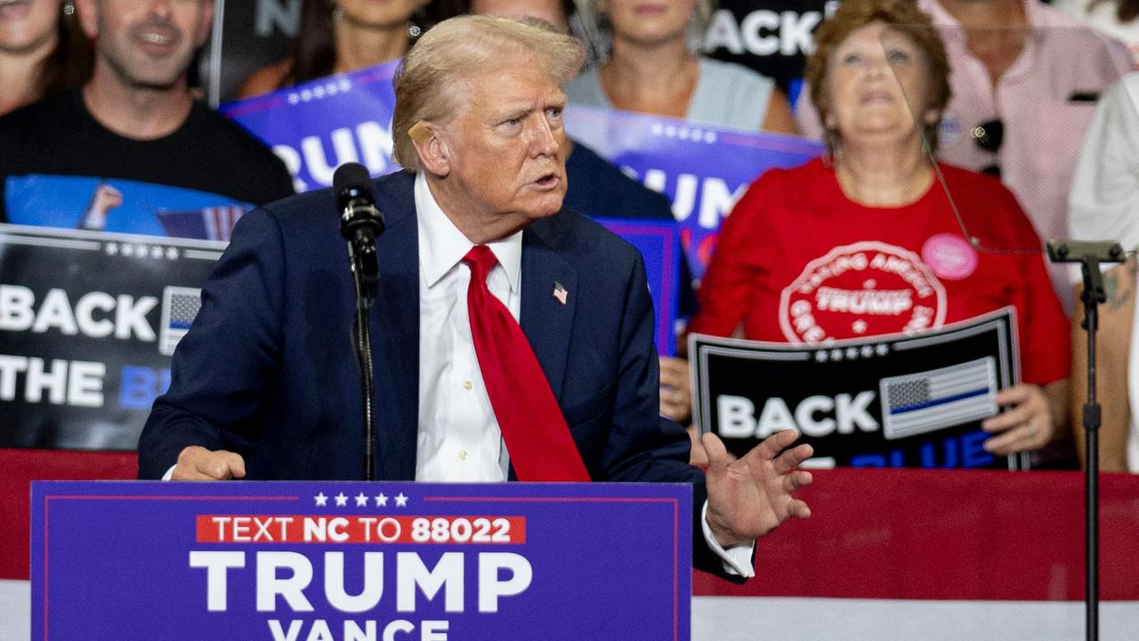 Former US president and 2024 Republican presidential candidate Donald Trump, a bandage on his ear after being injured during an assassination attempt, speaks during a campaign rally at the Bojangles Coliseum in Charlotte, North Carolina, on July 24, 2024. (Photo by Logan Cyrus / AFP)