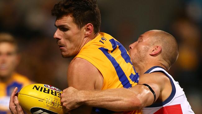 Scott Thompson wraps up West Coast’s Luke Shuey. Picture: Paul Kane (Getty Images)