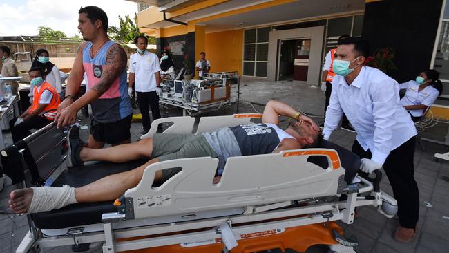 An injured foreign tourist receives medical attention at a makeshift unit set up outside the Moh. Ruslan hospital in Mataram on the Indonesian island of Lombok. Picture: AFP