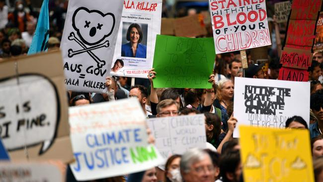 Demonstrators hold up placards at a climate protest rally in Sydney this week. Picture: Saeed Khan/AFP