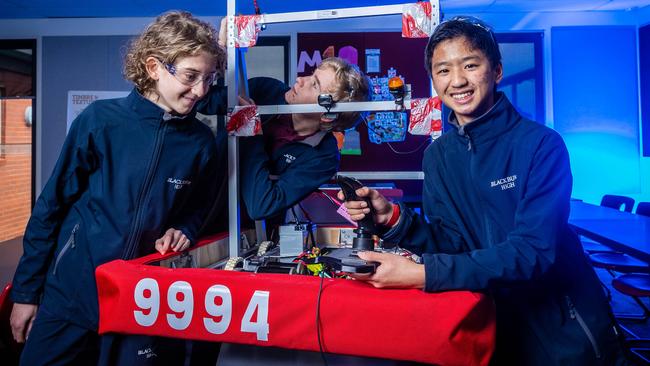 Students Cameron Goddard, Charlie Ford and Mitchell Wu with the robot they’ve built. Picture: Jake Nowakowski