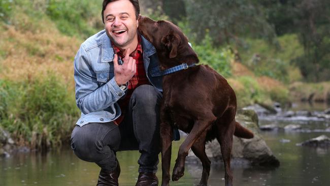 Gyton Grantley with his three-year-old Kelpie-Labrador cross, George, at Darebin Creek. Picture: Hamish Blair