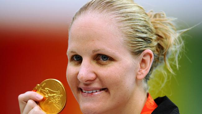 Kirsty Coventry celebrates on the podium holding her gold medal after the women’s 200m backstroke swimming final in 2008. Picture: AFP