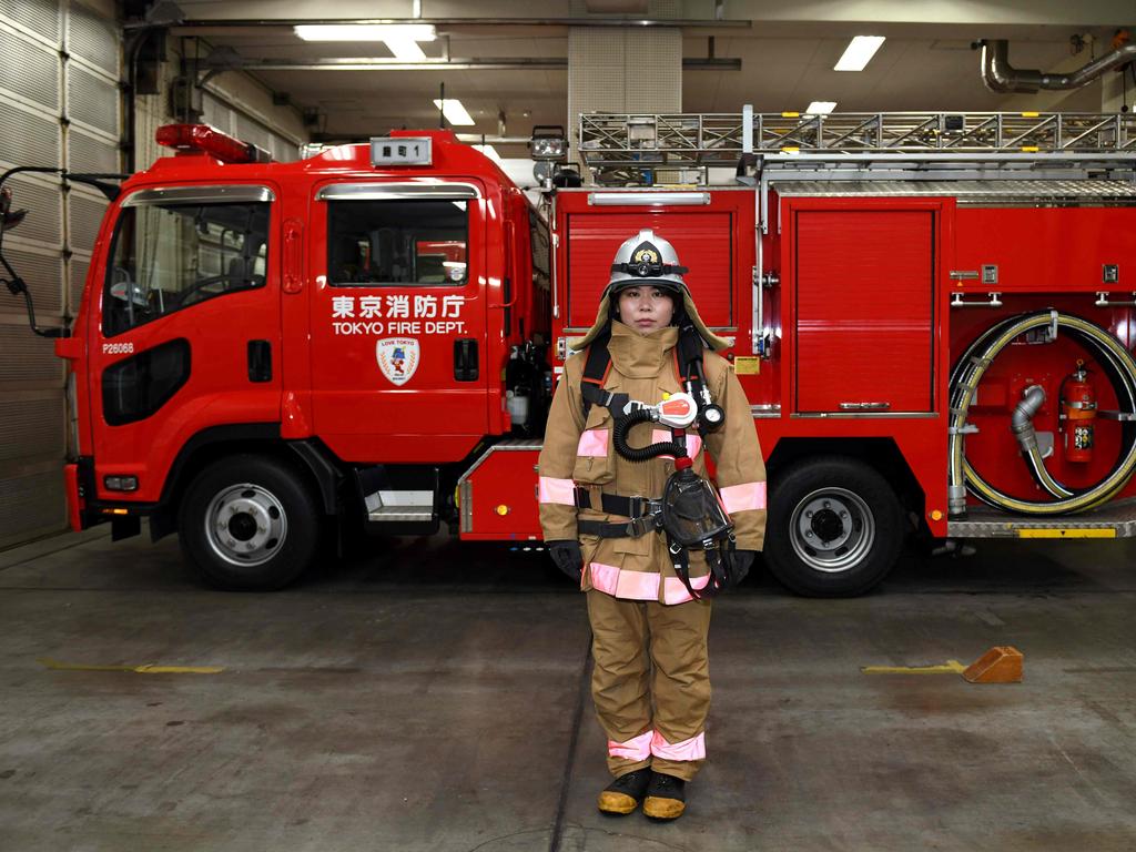 Ran Namise, 24, a firefighter belonging to the command squad, in front of a fire engine at Kojimachi Fire Station in Tokyo. Picture: AFP