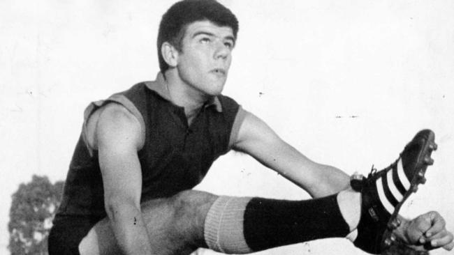 Woodville half-forward John Girardi launches a punt kick during training at Woodville Oval in 1970.