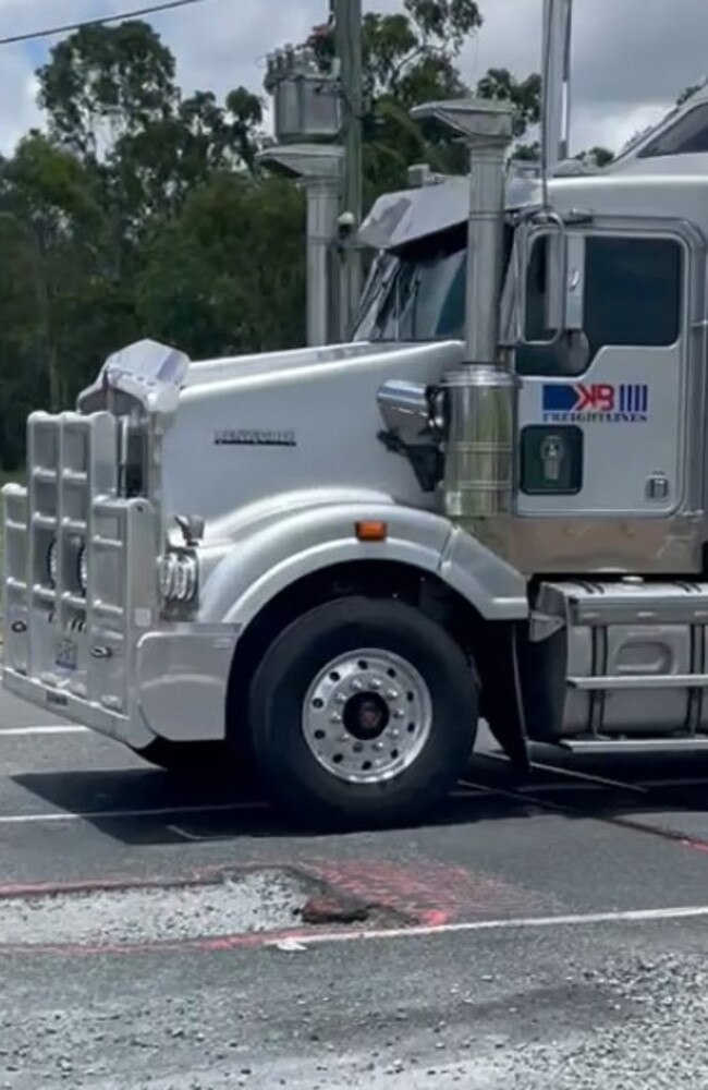 A truck near a pothole on the Bruce Highway. Picture: Mitchell Dyer