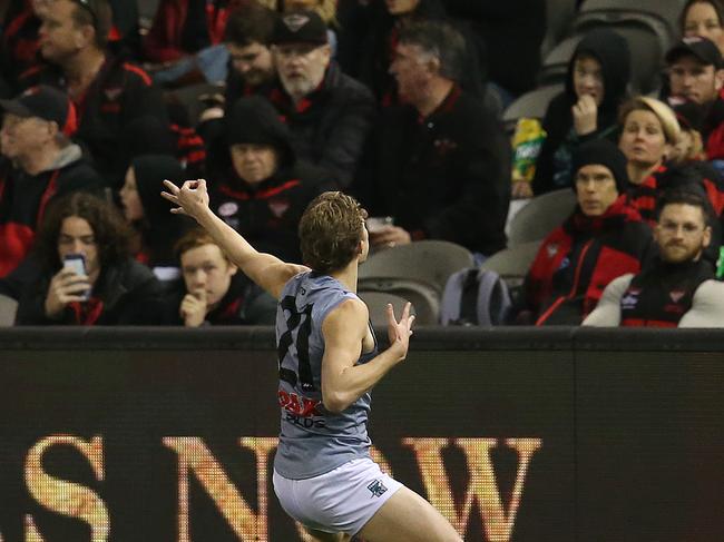 Xavier Duursma pulls out the bow and arrow in front of Essendon fans. Picture: Michael Klein