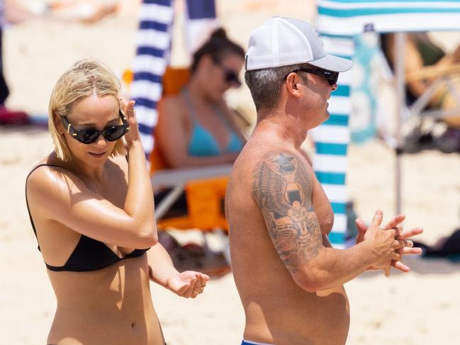 Michael Clarke and Jade Yarbrough on Noosa Beach on January 7, three days before they were filmed having an almighty row in a nearby park amid cheating accusations. Picture: Matrix Media