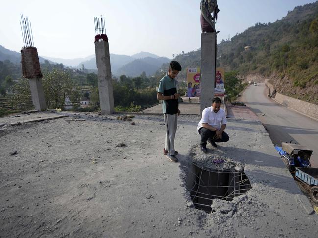 A man inspects the roof of a building that was damaged by Pakistani artillery shelling. Picture: AP Photo