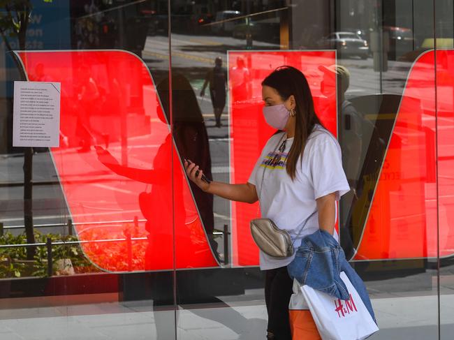 A woman walks past Westpac Bank signage in Melbourne on November 2, 2020, as the bank announced a 66 percent plunge in net profits in fiscal 2020, hammered by the coronavirus economic downturn and a record fine for breaches of money-laundering laws. (Photo by William WEST / AFP)