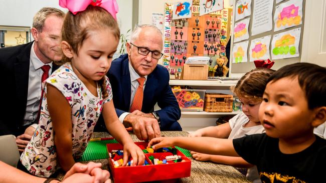 Australian Prime Minister Malcolm Turnbull (centre) speaks to children during a visit to the Teenie Weenies Learning Centre in Panania. Picture: Brendan Esposito/AAP