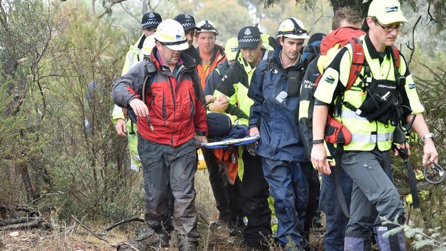 Found! Luke is brought out of the bush to a waiting ambulance. Picture : Mike Keating