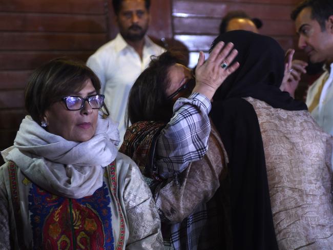 A Pakistani woman hugs a relative of Junaid Jamshed, a former Pakistani pop star turned evangelical Muslim, at his house in Karachi after his death in plane crash. Picture: AFP/Rizwan Tabassum