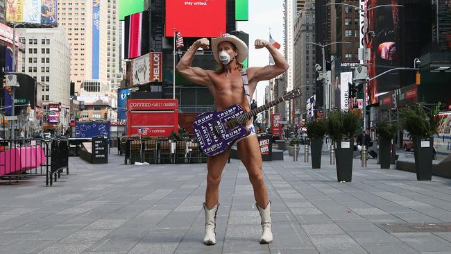 The world famous Naked Cowboy continues to perform in Times Square for sparse crowds. Picture: Bruce Bennett/Getty