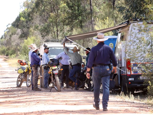 Police on the unsealed Wains Road, Wieambilla, leading to the property where two police officers and a neighbour were killed. Picture: Liam Kidston