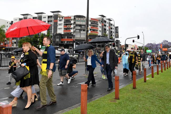 BRISBANE, AUSTRALIA - OCTOBER 24: Fans are seen arriving at the Gabba before the 2020 AFL Grand Final match between the Richmond Tigers and the Geelong Cats at The Gabba on October 24, 2020 in Brisbane, Australia. (Photo by Bradley Kanaris/AFL Photos/via Getty Images)