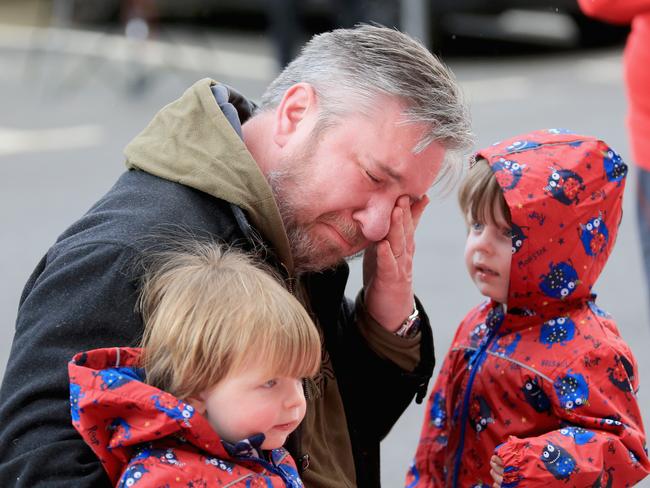 A man reacts to tributes at the Hillsborough Memorial outside Anfield Stadium, the home of Liverpool Football Club, after the verdict. Picture: Christopher Furlong/Getty Images