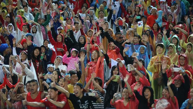 South Korean fans wave to their country's soccer team after the AFC Asian Cup semifinal soccer match between South Korea and Iraq in Sydney, Australia, Monday, Jan. 26, 2015. (AP Photo/Rick Rycroft)