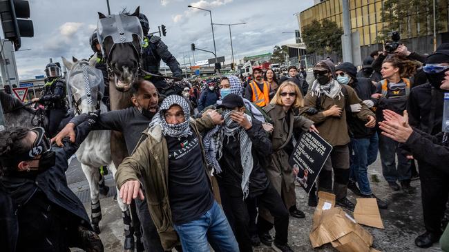 BEST PICS 2024 Anti-war activists protest the Land Forces 2024 International Land Defence Exposition at the Melbourne Convention and Exhibition Centre. Police mounted unit charges protesters at South Wharf. Picture: Jake Nowakowski