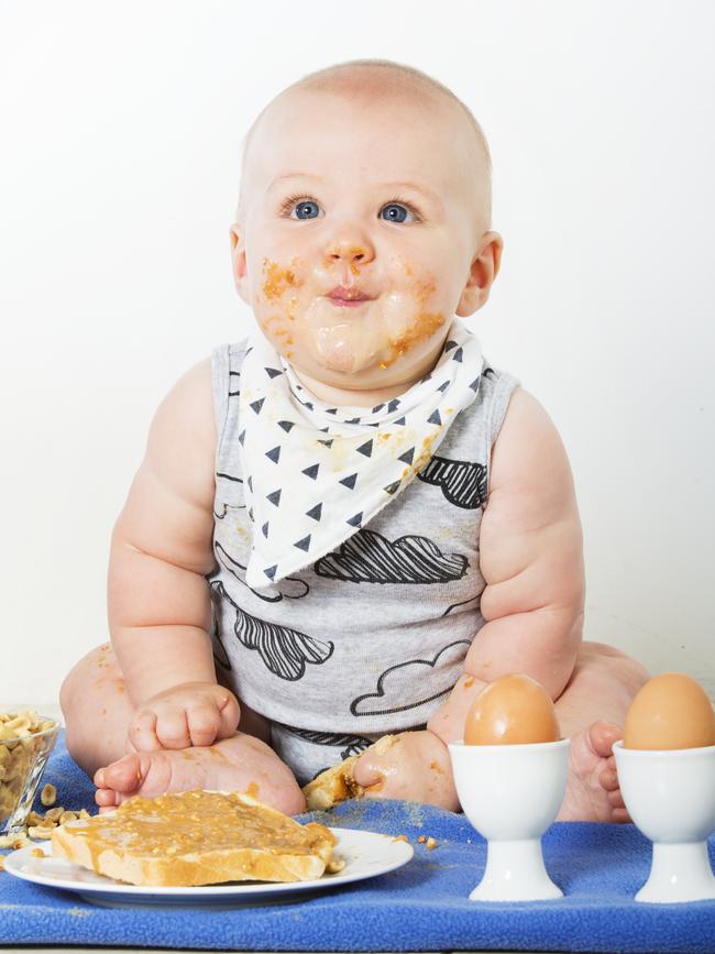 Six-month-old Lawson Thatcher ,of Yandina, tries out some peanut butter on toast. Picture: Lachie Millard