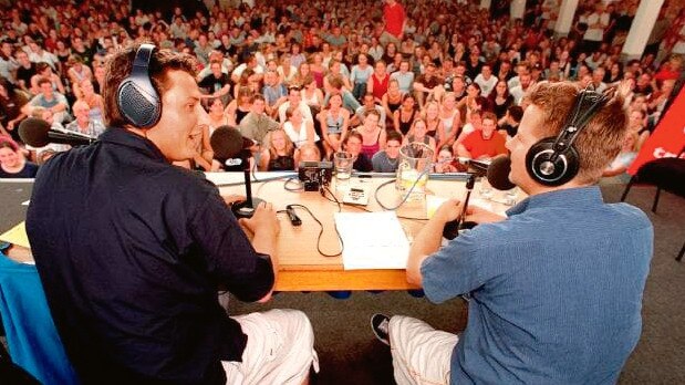 With comedy partner Tim Ross doing their Triple J radio show before a live audience.