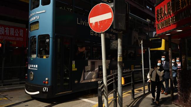 People walk past a tram in Hong Kong as the city copes with a fourth wave of COVID-19. Picture: AFP