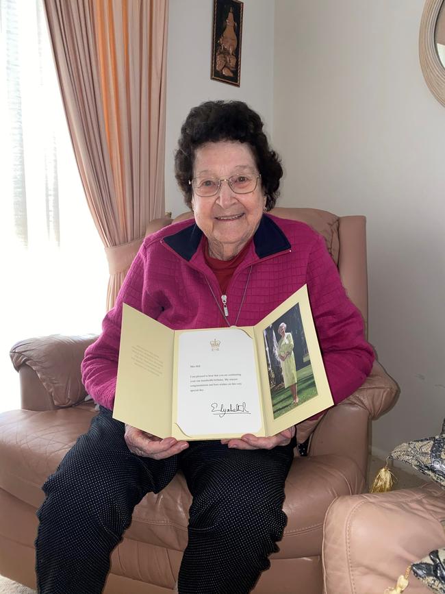 Agnes Hill with her letter from the Queen.