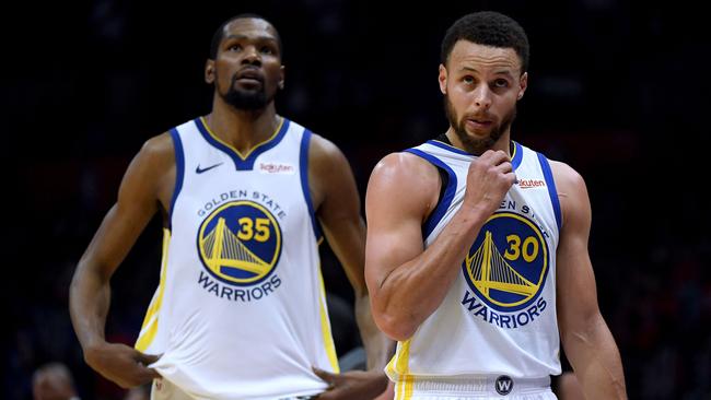 LOS ANGELES, CALIFORNIA - APRIL 26:  Stephen Curry #30 and Kevin Durant #35 of the Golden State Warriors react as they leave the game late in the fourth quarter with a lead in a 129-110 win over the LA Clippers during Game Six of Round One of the 2019 NBA Playoffs at Staples Center on April 26, 2019 in Los Angeles, California. (Photo by Harry How/Getty Images)  NOTE TO USER: User expressly acknowledges and agrees that, by downloading and or using this photograph, User is consenting to the terms and conditions of the Getty Images License Agreement.