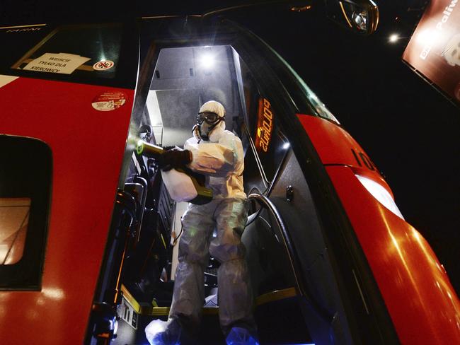 A sanitary worker disinfects a bus at the end of the day in Warsaw, Poland. Picture: AP