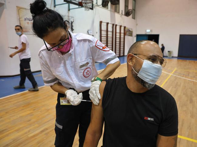 A paramedic with Israel's Magen David Adom medical service administers the third shot of the Pfizer-BioNTech Covid-19 vaccine on August 24, 2021 in Holon. Picture: AFP