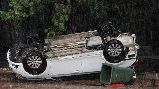 Car on its roof at Nambour after serious flooding swept through. Picture Lachie Millard