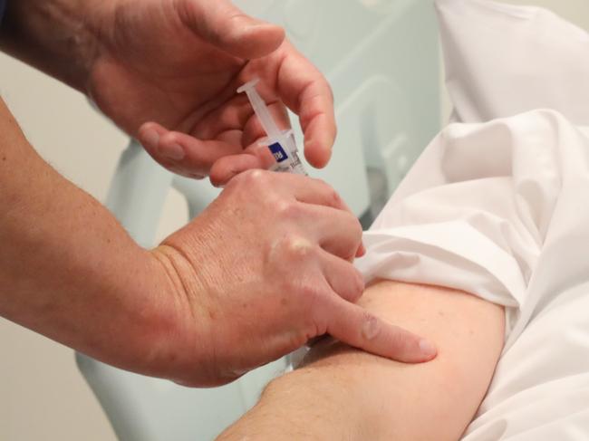 ADELAIDE, AUSTRALIA NewsWire Photos June 30: COVID VACCINE HUMAN TRIALSHuman trials of covid vaccine to start at RAH (Royal Adelaide Hospital). Guy Ludbrook, Professor of Anaesthesia, administers the first vaccine to Pharmacist, Ian Tindall.  NCA NewsWire / Dean Martin