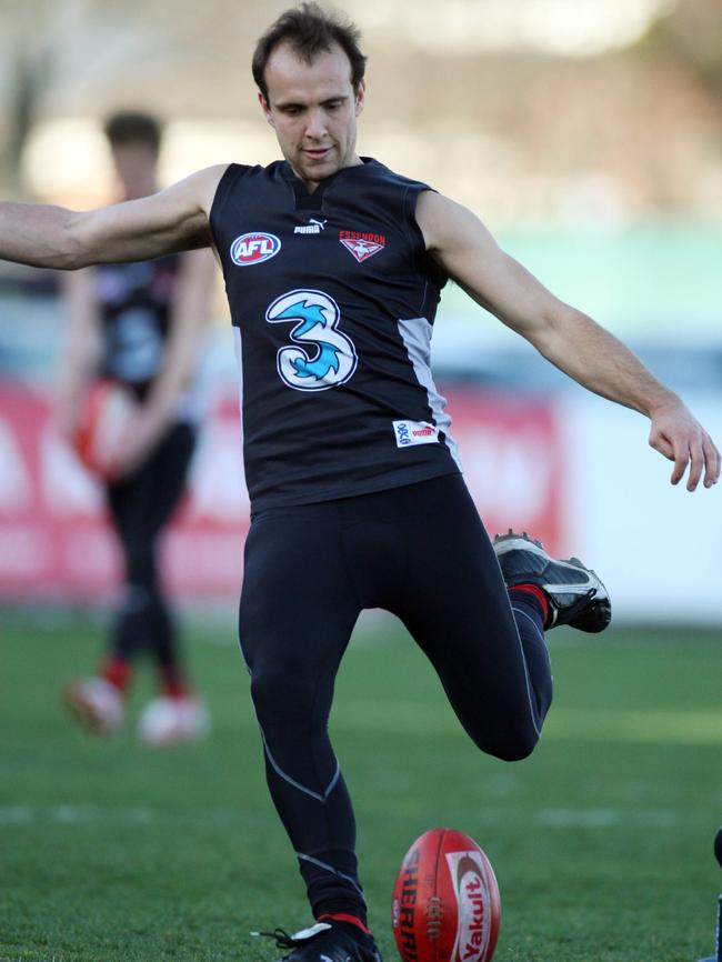 Former Essendon player Adam Ramanauskas tries a place kick.