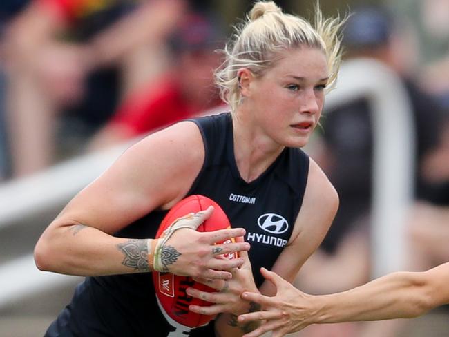 ADELAIDE, AUSTRALIA - MARCH 01: Tayla Harris of the Blues evades Sophie Li of the Crows  during the 2020 AFLW Round 04 match between the Adelaide Crows and the Carlton Blues at Hisense Stadium on March 1, 2020 in Adelaide, Australia. (Photo by Matt Turner/AFL Photos via Getty Images)