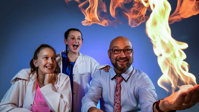 Sisters Lilli and Mia Bennett watch on as Lee Harrison does a science demonstration ahead of this year's Tour Down Under's 'Science with Santos' at the the Tour Village, which aims at bring science to young cycling enthusiasts. Picture: Bianca De Marchi