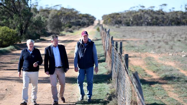 South Australian Dog Fence Board chairman Geoff Power, Primary Industries Minister Tim Whetstone and West Coast farmer Craig Trowbridge inspect the Dog Fence. Picture: TRICIA WATKINSON