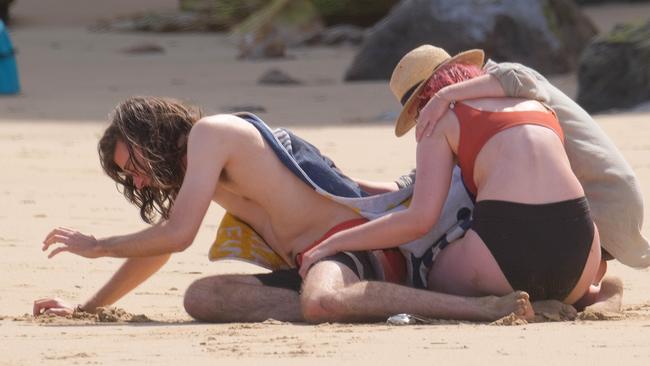 Distraught beachgoers console each other. Picture: Mark Wilson