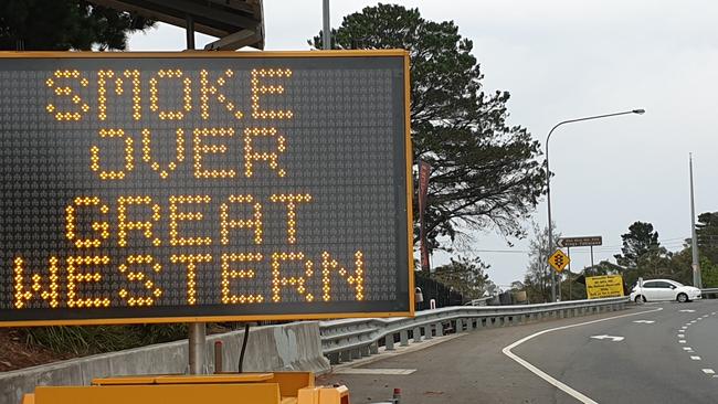 A sign at Kings Tableland Rd turn-off, Wentworth Falls, alerts motorists to back burning smoke. Firefighters will also back burn from Woodford, south along the Bedford Creek Fire Trail and along Oaks Fire Trail, heading south and then east to the Nepean River. Picture: Isabell Petrinic