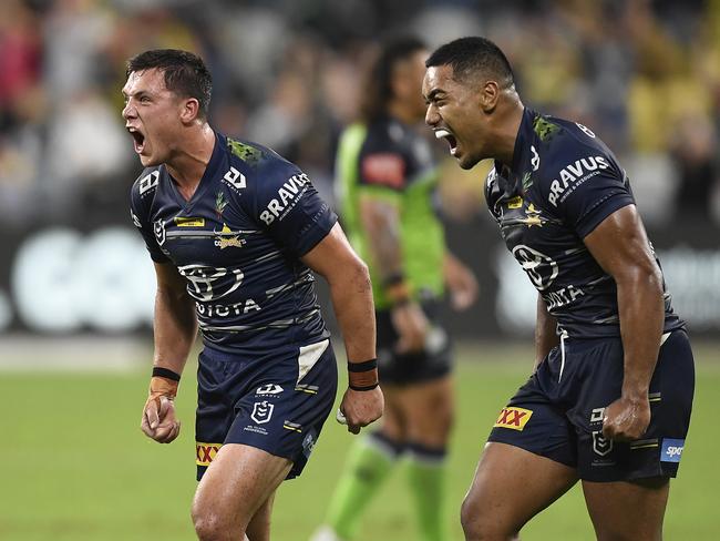 TOWNSVILLE, AUSTRALIA - APRIL 24: Scott Drinkwater and Connelly Lemuelu of the Cowboys celebrate after winning the round seven NRL match between the North Queensland Cowboys and the Canberra Raiders at QCB Stadium, on April 24, 2021, in Townsville, Australia. (Photo by Ian Hitchcock/Getty Images)