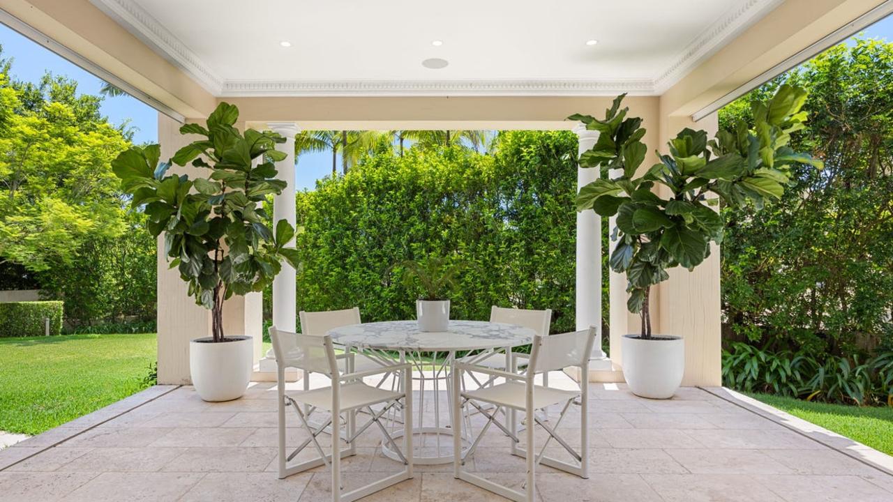 The apartment opens to a terrace and frangipani and jacaranda-framed lawn. which is on title.