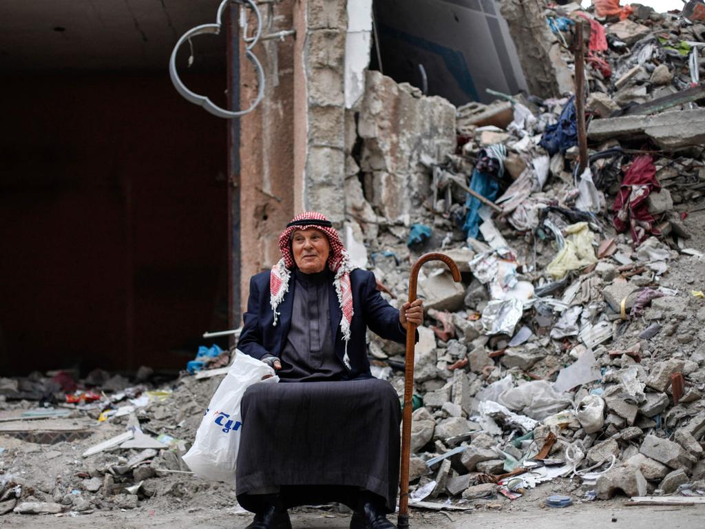 A Palestinian man sits in front of the rubble of a building in the Maghazi camp for Palestinian refugees. Picture: AFP